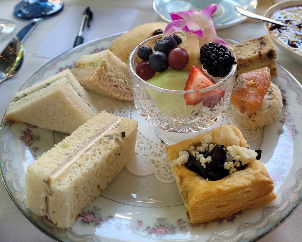 a plate of fancy tea sandwiches.